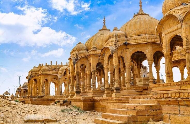 Panoramic view of Bada Bagh Jaisalmer showing ancient cenotaphs set against the desert landscape at sunset
